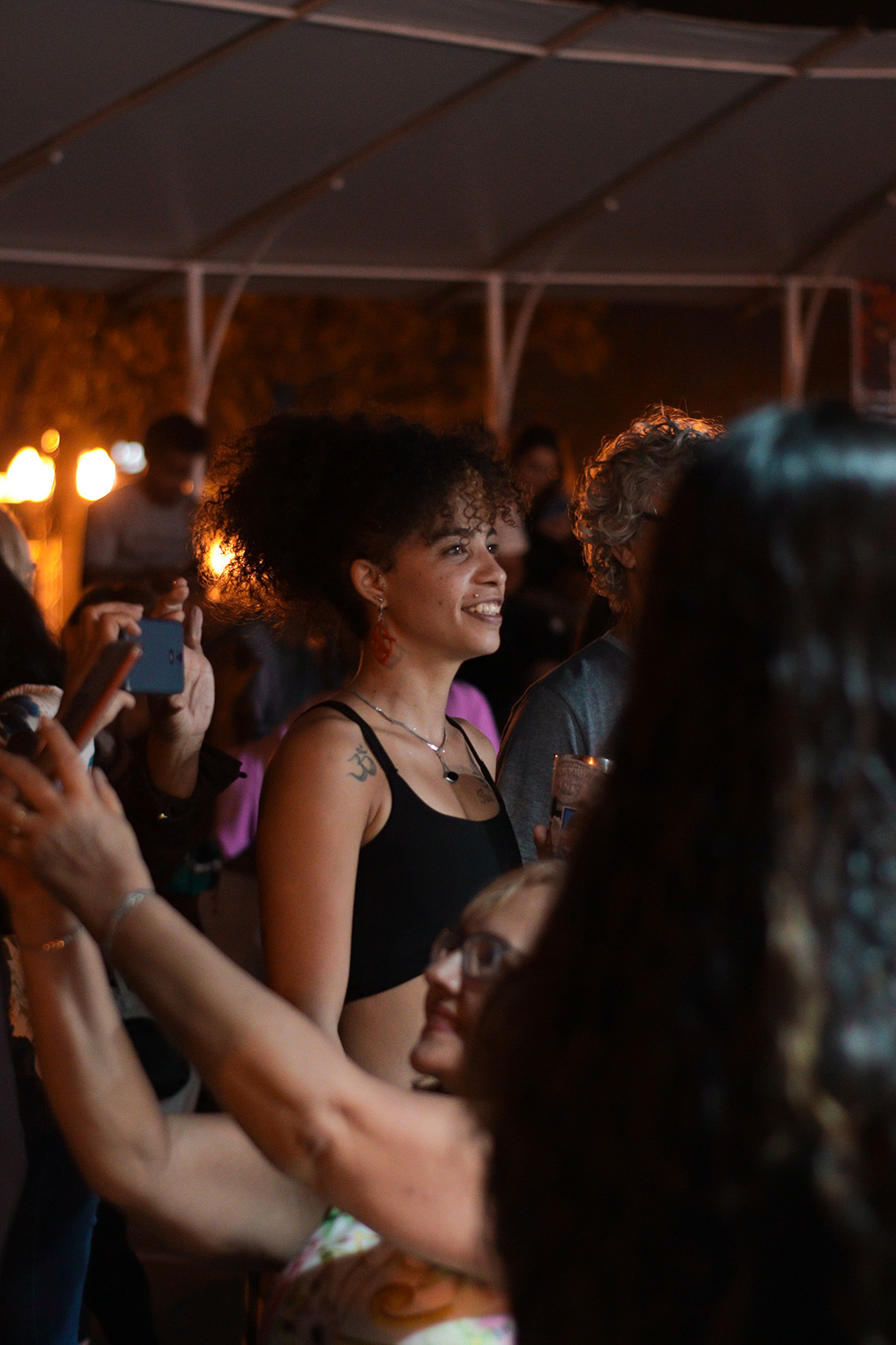 Sorriso no meio da plateia sob a tenda